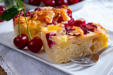 Fresh baked cake with red ripe juicy sour cherry or kriek berry