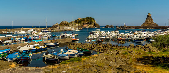 Panorama view of  the fisherman's harbour and Isole dei Ciclopi at Aci Trezza, Sicily in summer