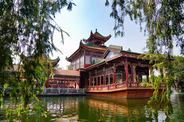 historic garden with traditional structures and popular water features filled with koi fish. Baomo park, Guangzhou China	