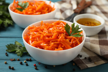 Composition with tasty carrot salad on wooden background. Korean carrot
