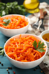 Composition with tasty carrot salad on wooden background. Korean carrot