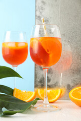 Composition with aperol spritz cocktail on white table. Summer drink