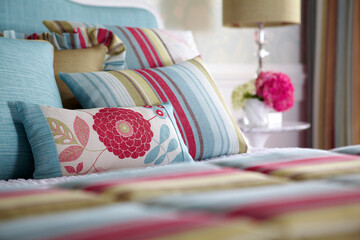 Multi-colored pillows on bed