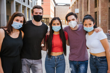 Group of young millennial friends taking a photo with smartphone and they wearing a facial masks...