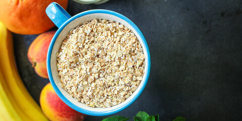 oatmeal in a cup and fruits Menu concept serving size. food background top view copy space for text organic healthy eating raw