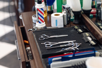 top view of professional barber tools and blank black card on wooden table