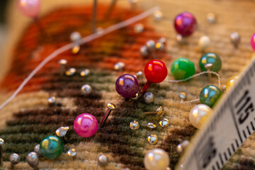 Detail of different objects that we can find in a sewing box: threads, needles, pins, thimble, tape measure