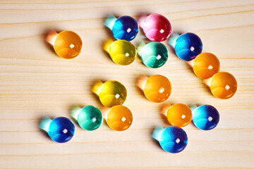 Bright transparent spheres scattered on the wooden table. Lush jelly balls. Food and drink backgrounds