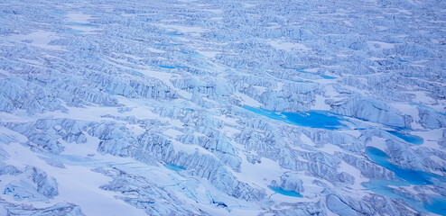 Wide aerial of glacier in greenland with glacial rivers and lakes