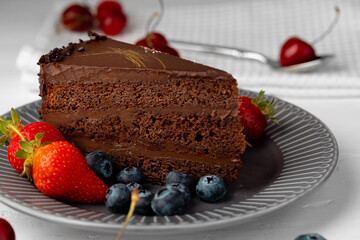 Piece of chocolate cake served with fresh berries
