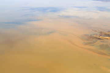 Aerial view of the salt pan and mineral crust of Lake Natron, in the Great Rift Valley, on the border between Kenya and Tanzania. The Rift Valley contains a chain of active volcanoes.