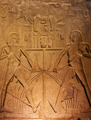 Hieroglyphic carvings on wall at Luxor Temple during night