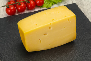 Hard yellow tasty cheese brick