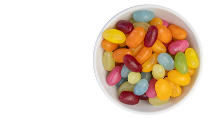 Jelly beans in bowl, isolated on white. Copy space on left. Colorful background.