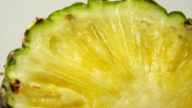 4K Sliced pieces of delicious pineapple fruit. Tropical food. Rotate