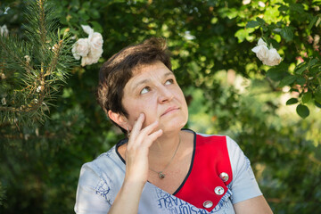 Picture of a middle-aged woman. Concept of emotions. Woman is happy to have rest outdoors after...