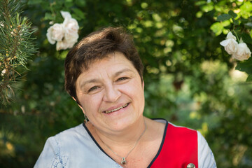 Picture of a middle-aged woman. Concept of emotions. Woman is happy to have rest outdoors after...