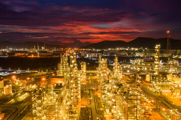 Fototapeta na wymiar Aerial view Oil refinery.Industrial view at oil refinery plant form industry zone with sunrise and cloudy sky.Oil refinery and Petrochemical plant at dusk Thailand. Oil refinery background.