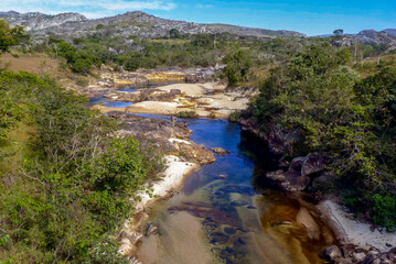 Ribeirao do inferno river, with vast vegetation on the banks and mountains in the background, municipality of Diamantina, state of Minas Gerais, Brazil