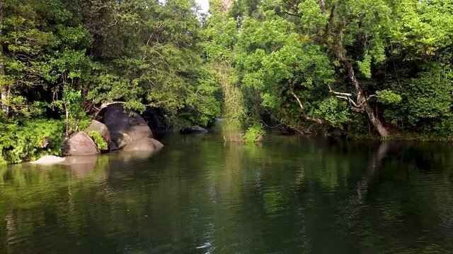 Green Rivers With Large Boulders Surrounded By Lush Rainforest In Babinda Boulders, Cairns In Queensland, Australia - Long Shot (Forward)