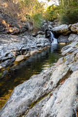 Naklejka na ściany i meble Belchior waterfall, flowing between rocks, with forest beside it, Caraca sanctuary, Catas Altas city, Minas Gerais state, Brazil
