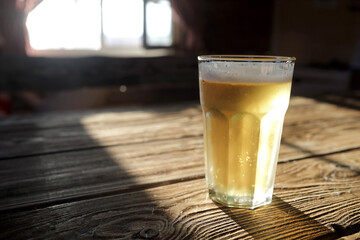 Glass of beer lit by light