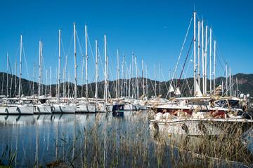 Yacht Marina. Footage of many luxury boats and yachts in the harbor. Beautiful forested mountain landscape in the background. Gocek Marina, Mediterranean coast, Fethiye TURKEY