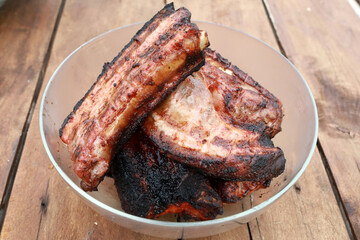 Grilled pork ribs in bowl