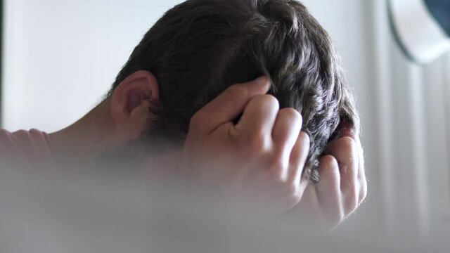 Desperate stressed man covers face in anxiety, depression concept
