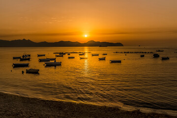 A flotilla of small boats moored at Aspra Sicily at sunset on a summer's evening
