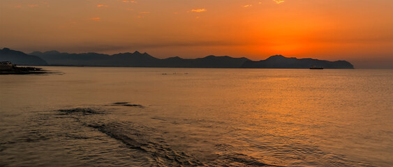 A glorious sunset agross the Gulf of Palermo as seen from the beach at Aspra Sicily on a summer's evening