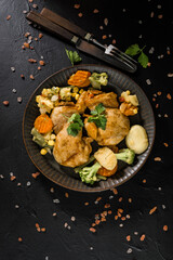 Fried chicken fillet with vegetables.