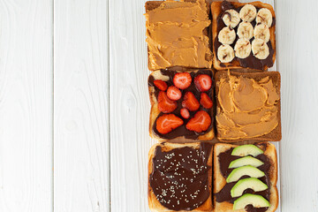 Assortment of sweet sandwiches with chocolate paste, peanut paste and fruit slices