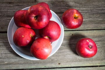 Red apples on wooden background. Copy space.