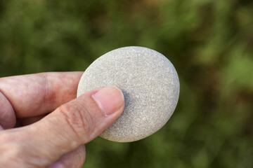 Man holding a stone in his hand