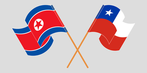 Crossed and waving flags of North Korea and Chile