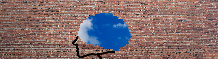 image of a brick wall fragment and blue sky behind a brick wall