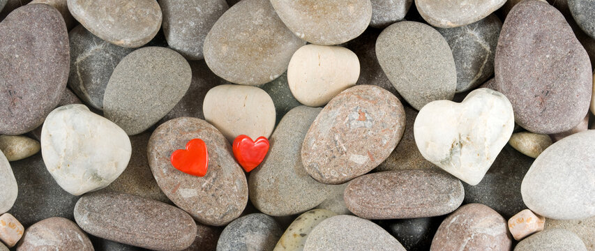 image of stones on the beach and two stylized stones as a symbol of love and devotion
