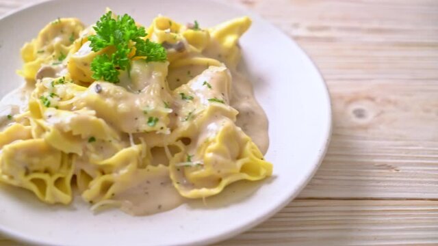 tortellini pasta with mushroom cream sauce and cheese - Italian food style