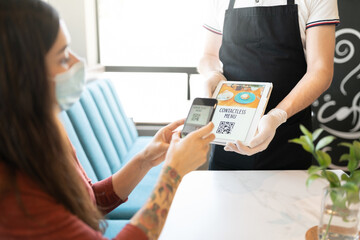 Waiter Showing Contactless Menu To Customer