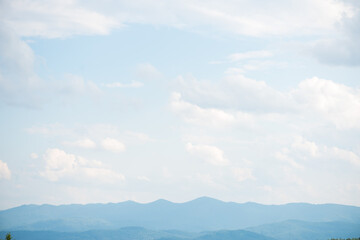 Blue sky with clouds over the forest