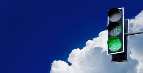 image of a traffic light on a city road against the sky