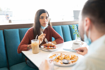 Couple Having Sweet Food In Restaurant