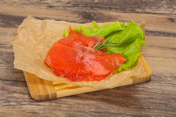 Sliced salmon fillet served rosemary