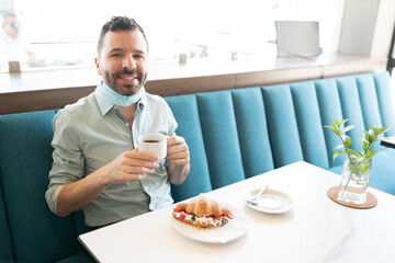 Smiling Man Having Coffee In Cafe