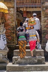 Women and men enter the temple complex of Tirta Empul.