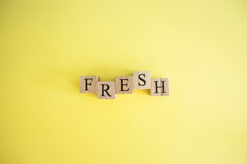 Fresh word made of wooden cubes. Food and nutrition concept.