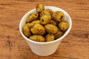 Green grilled olives in the bowl