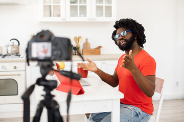 Handsome man recording video business course at home
