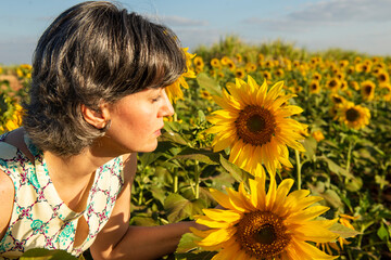 middle-aged woman in a sunflower plantation